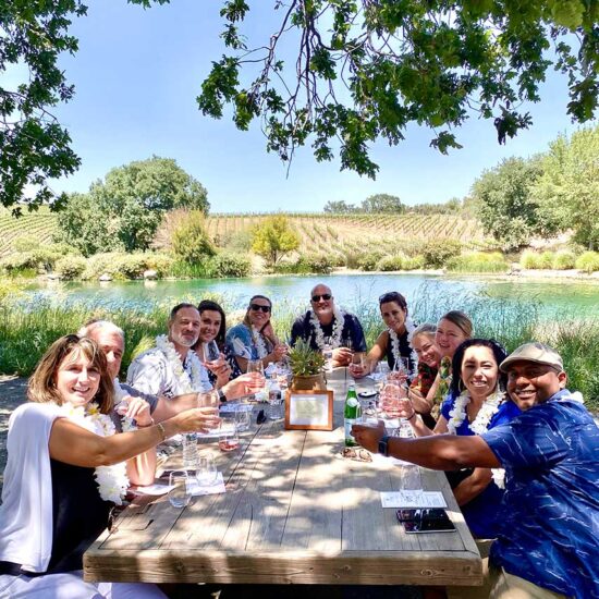 A group of corporate work colleagues enjoying a corporate event retreat at a Winery in Santa Barbra Wine country